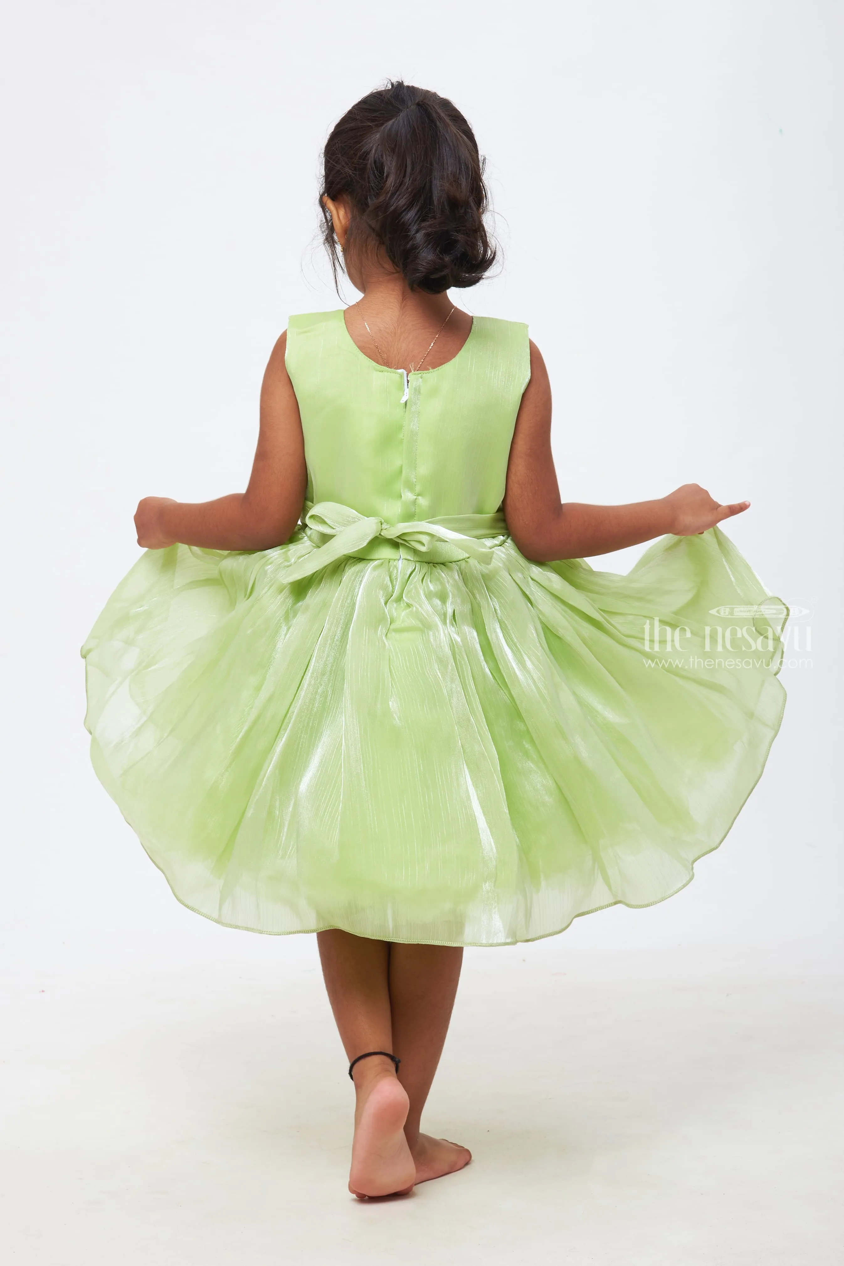 Emerald Enchantment: Girls Soft Green Tulle Dress with Rosette Accents